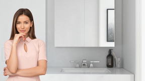 A woman standing in front of a bathroom sink