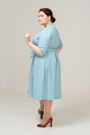 Side view of a happy woman in blue dress