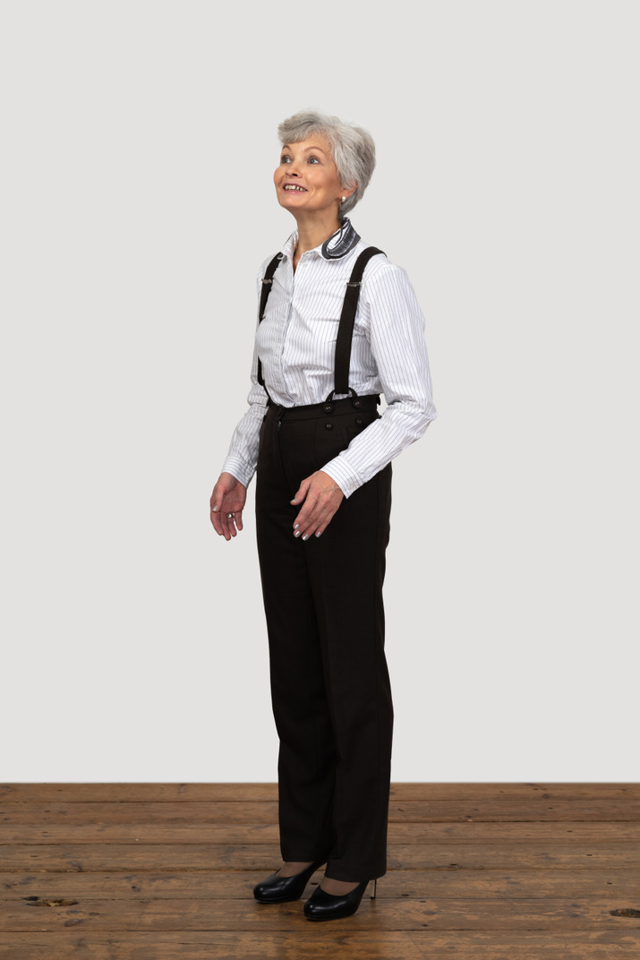 Three-quarters view of a hopeful old female dressed in office clothes