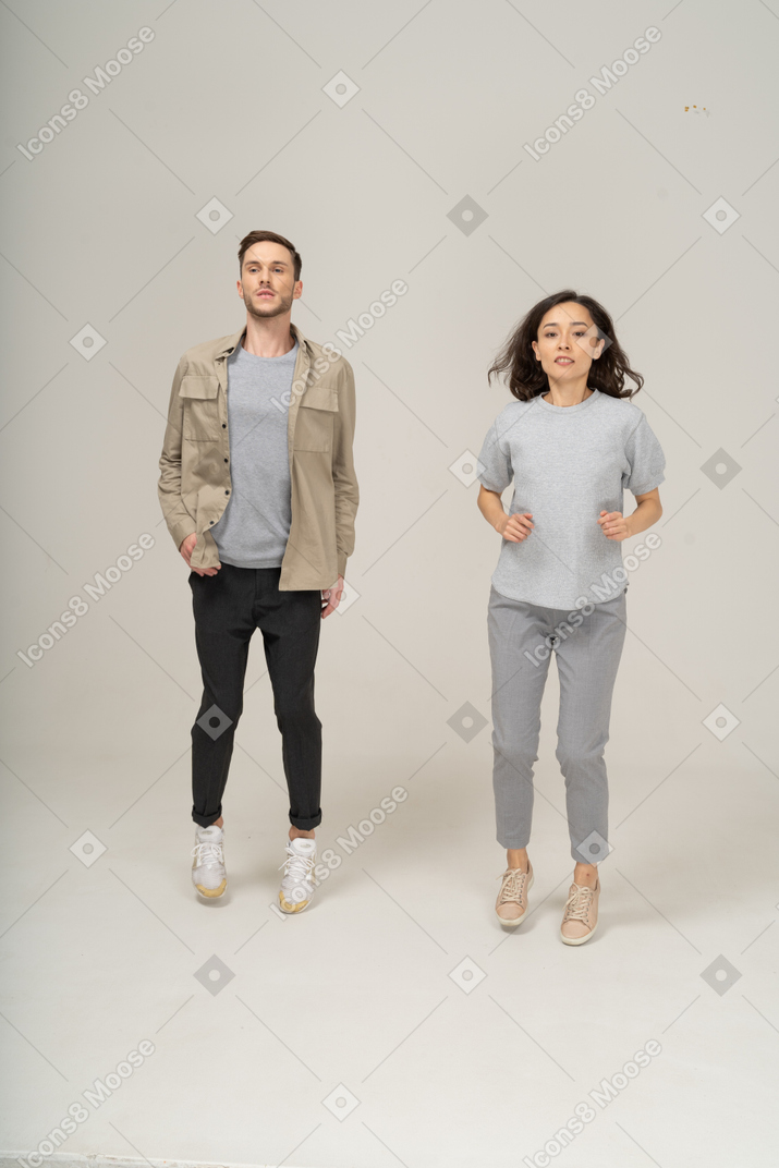 Young man and woman in the air jumping