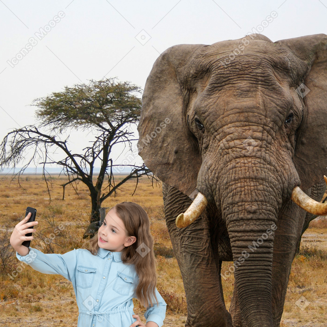 A young woman taking a photo of an elephant