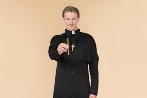 Catholic priest holding candle