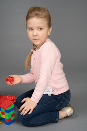 A little girl playing lego