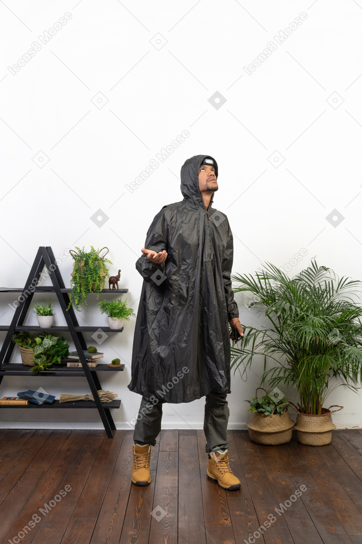 Mann im regenmantel wartet auf den regen