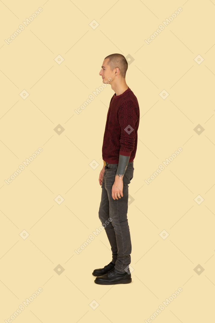 一个年轻人在红色套头衫站着不动的前视图