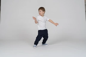Three-quarter view of a boy looking warily over his shoulder