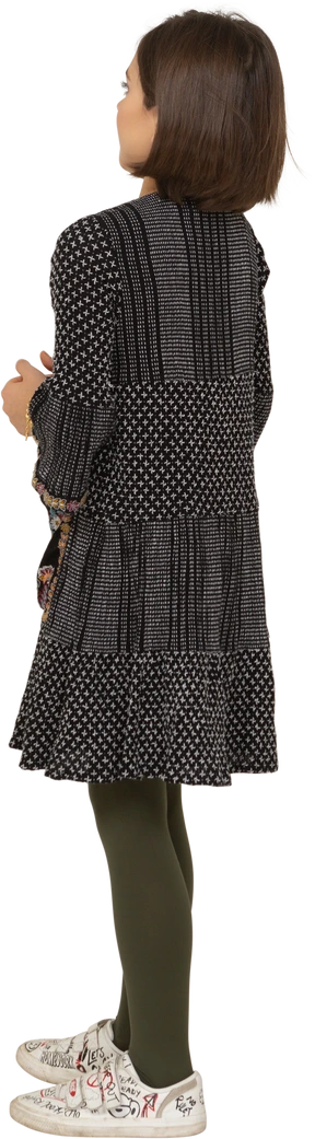Three-quarter back view of a confused little girl in dress holding hands together