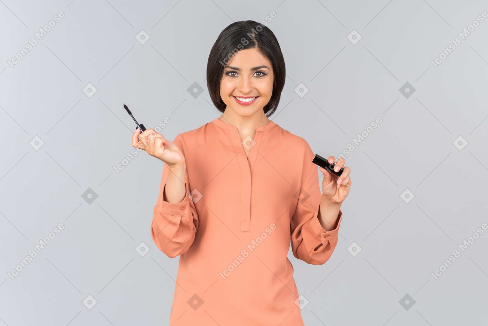 Dreamy looking indian woman holding mascara