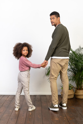 Father and daughter hold hands