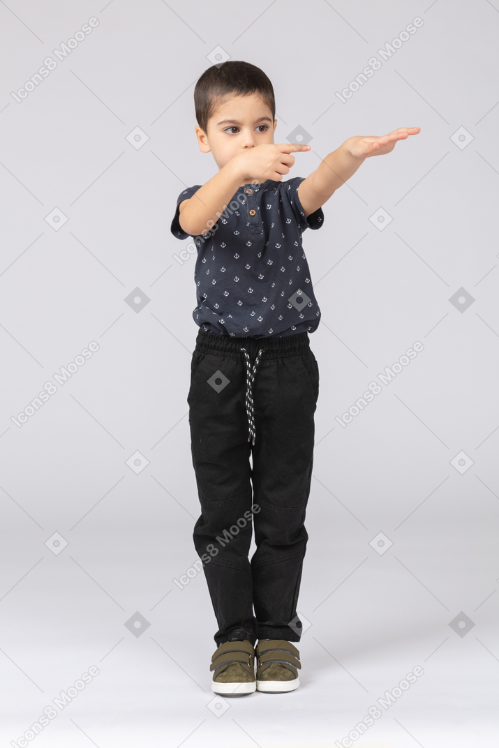 Front view of a cute boy showing direction