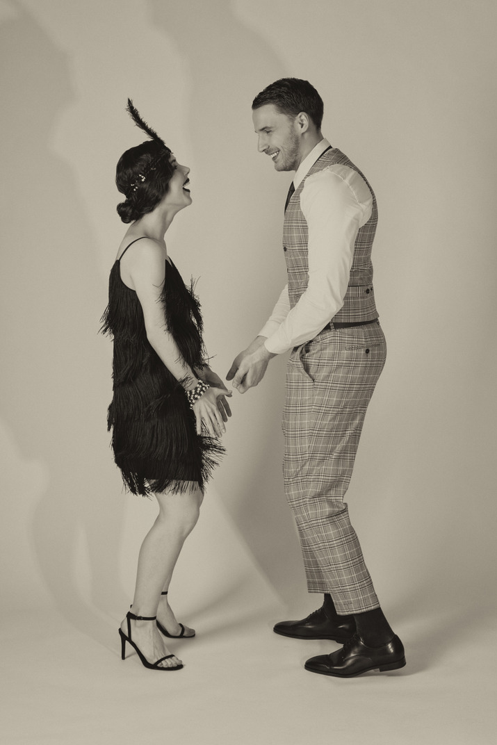 Excited young couple performing charleston dance