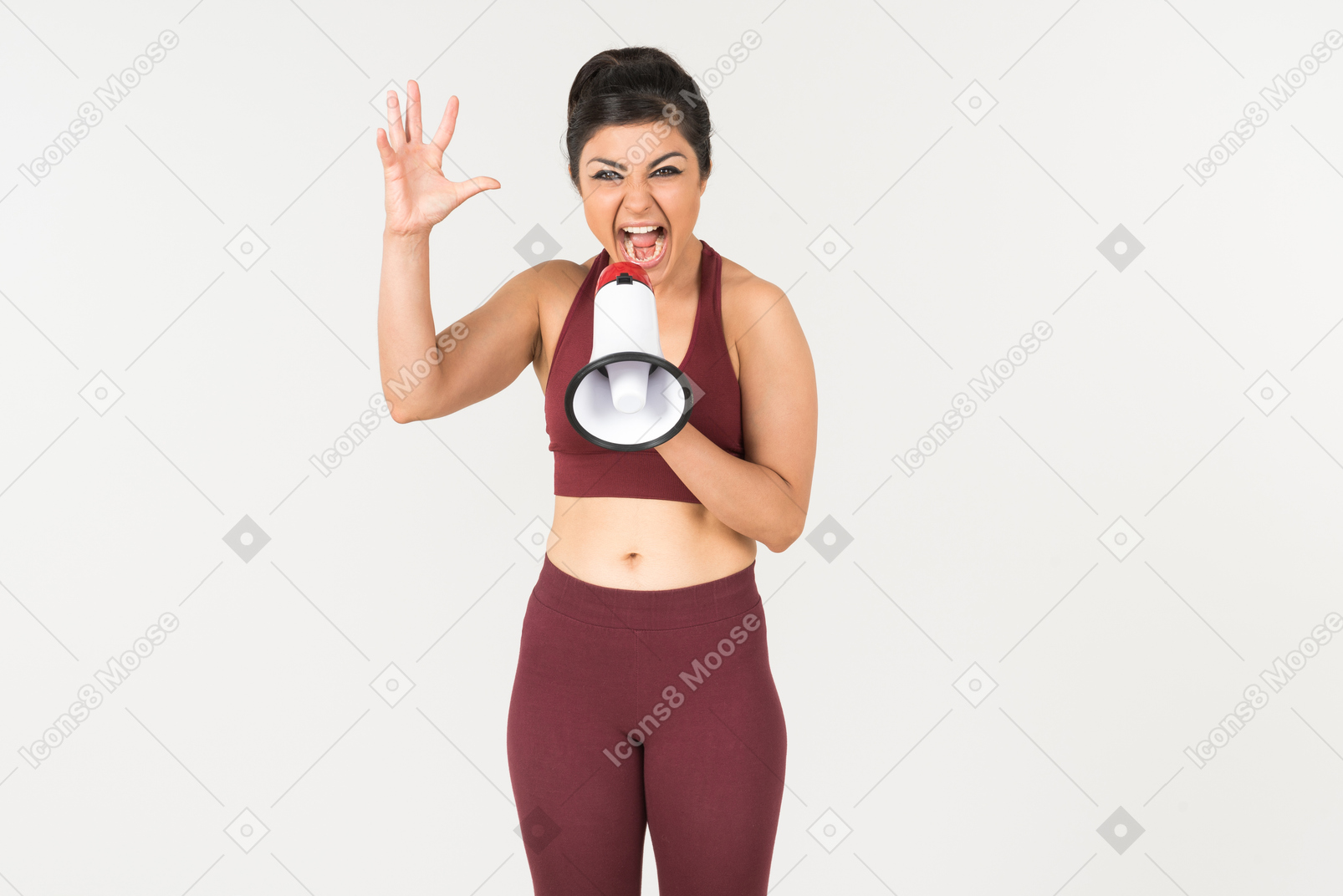 Angry looking young indian woman screaming using megaphone