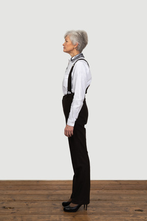 Side view of a confident old female dressed in office clothes