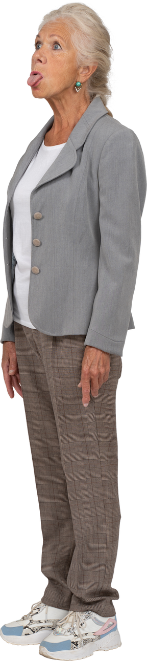 Vista laterale di una vecchia signora in abito che mostra la lingua