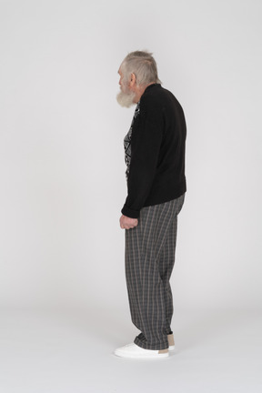 Profile view of a standing senior man