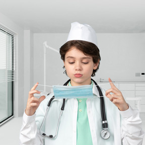 Boy putting on a face mask