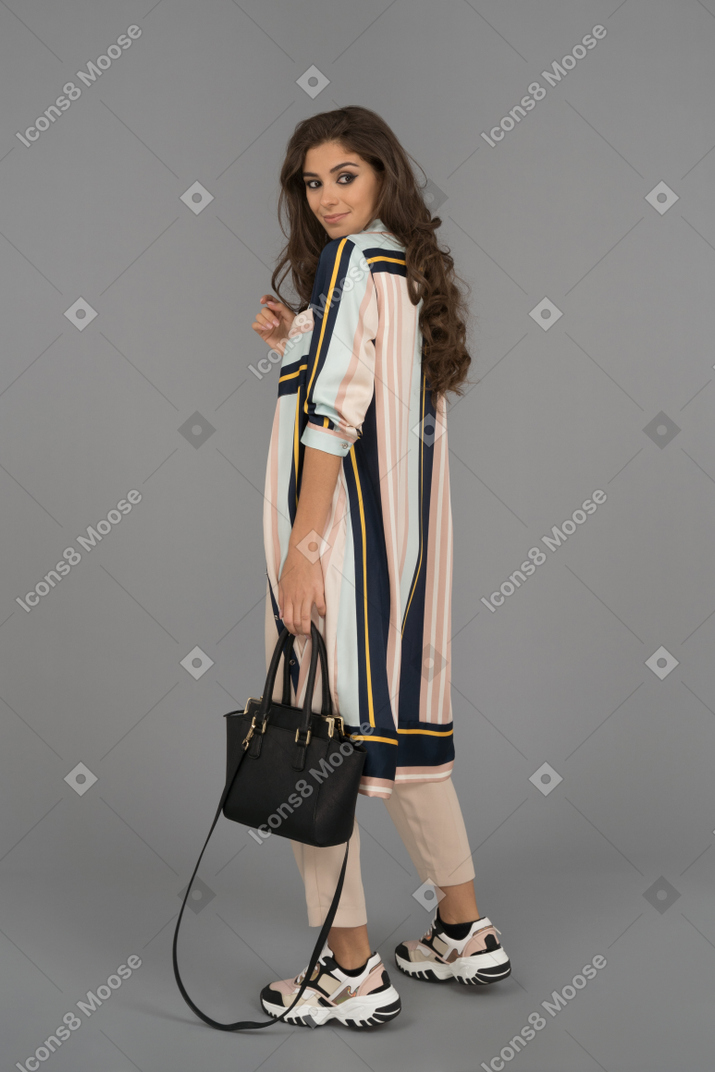 Attractive female posing with black handbag