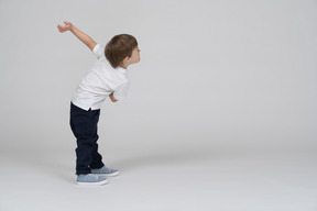 Side view of a boy showing a welcoming gesture