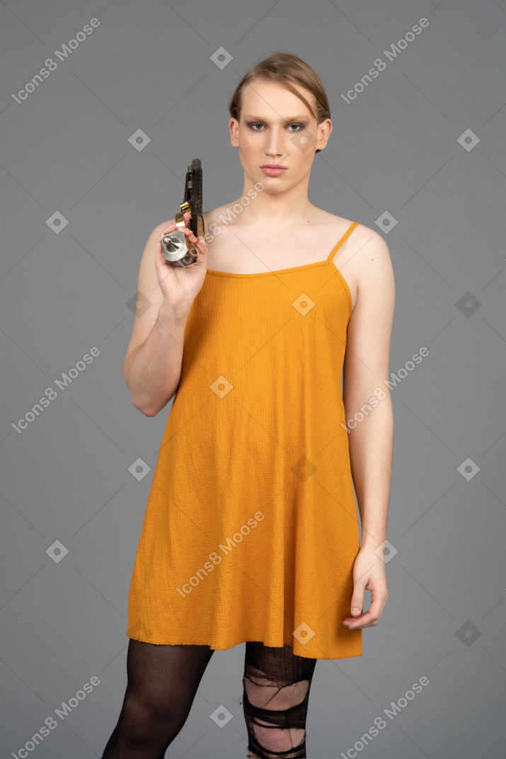 Front view of a genderqueer person carrying a gun