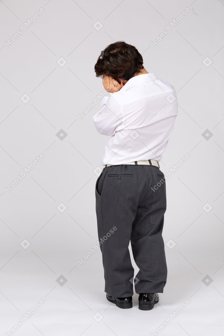Back view of an office worker with hands under cheek