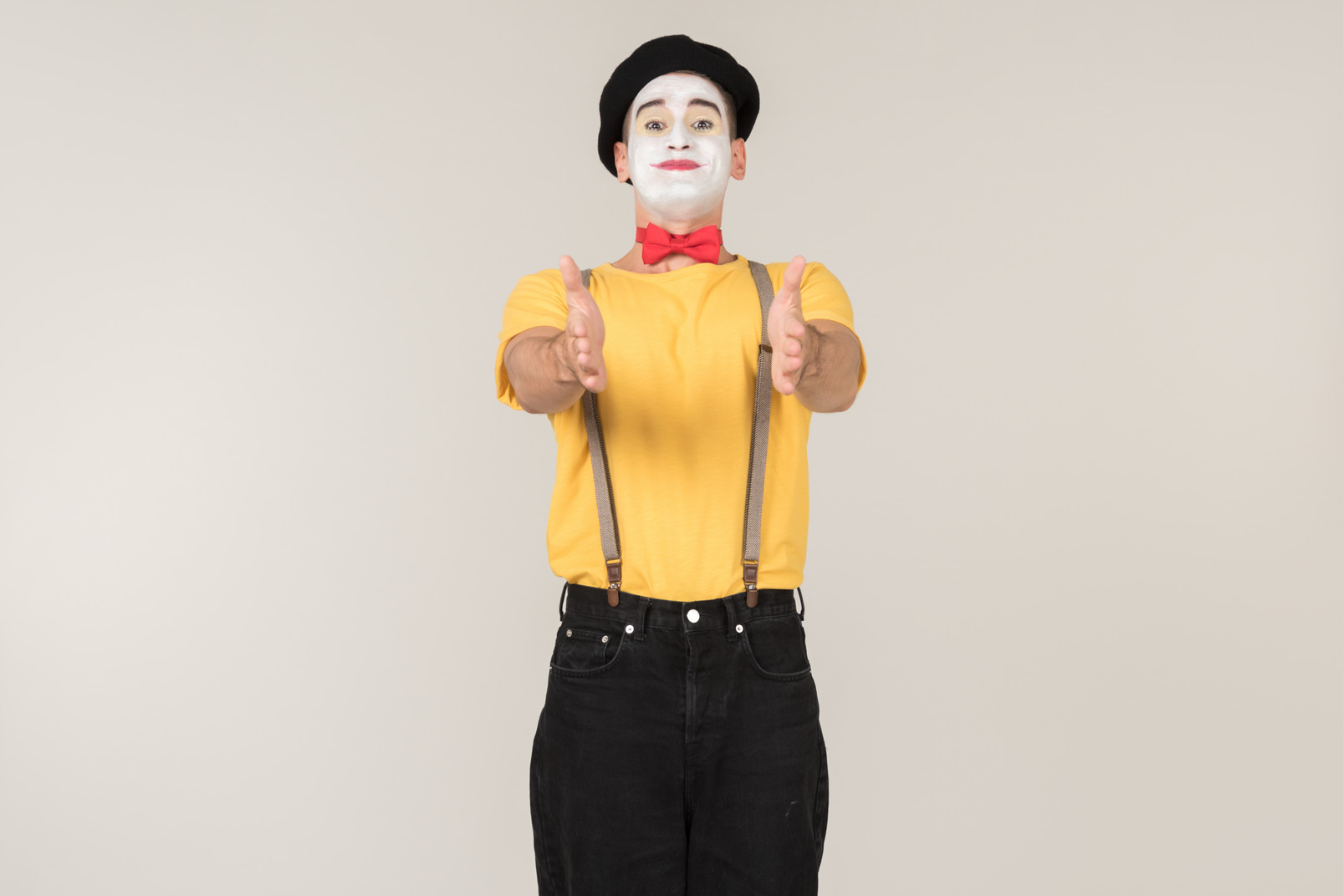 Smiling mime pointing forward with both hands