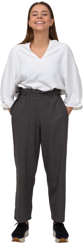 Front view of a smiling young lady in office clothing putting hands in pockets
