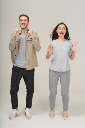 Joyful young couple cheering