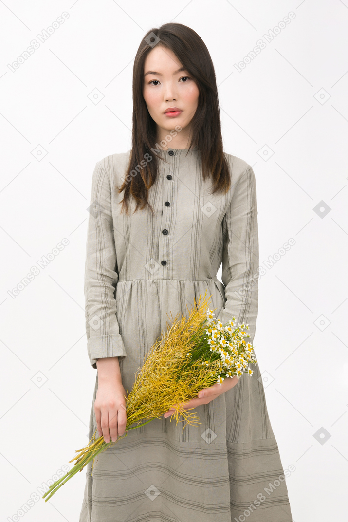 Girl holding a bouquet of wild flowers