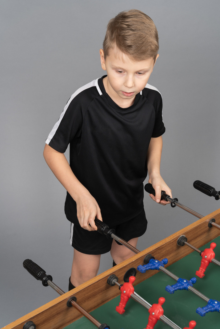 Close-up of a boy playing foosball