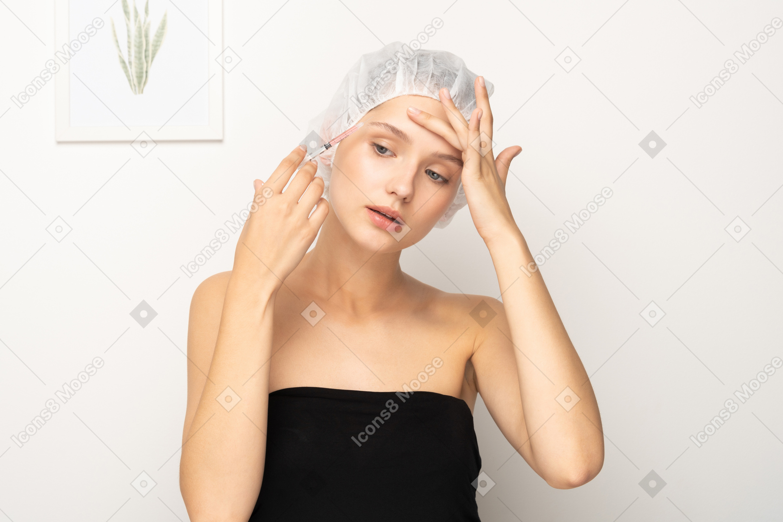 Woman making injection to her forehead