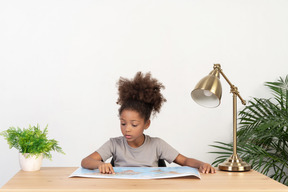 Good looking cute girl with books at the table