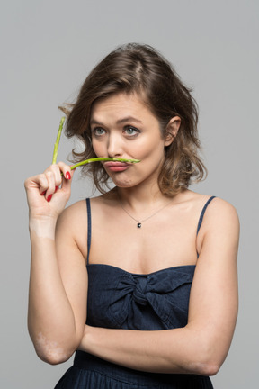 Thoughtful young woman with asparagus