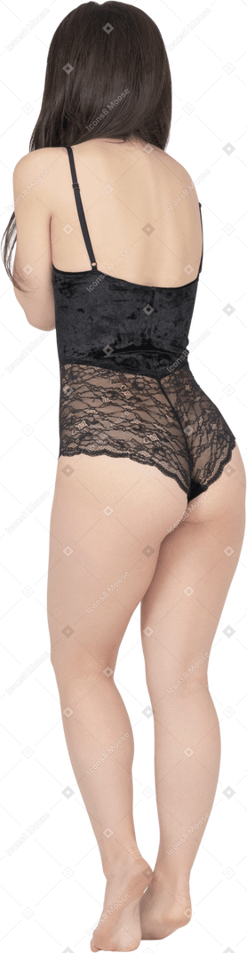Caucasian woman in black bodysuit posing in profile