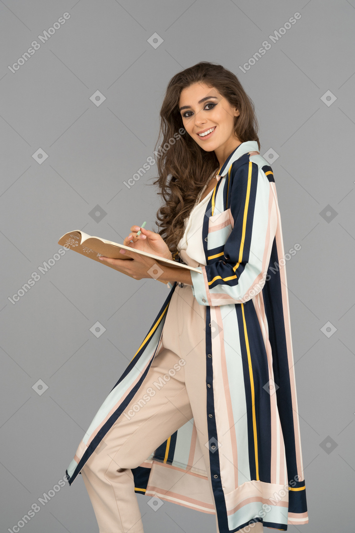 Cheerful young woman with a notebook