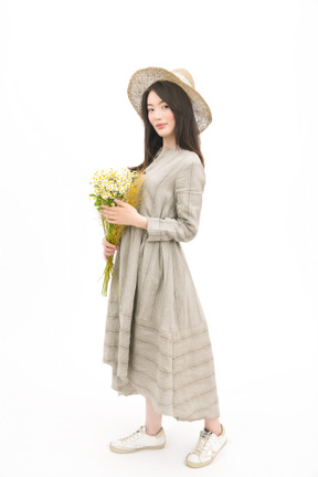 Girl in gray dress holding a bouquet