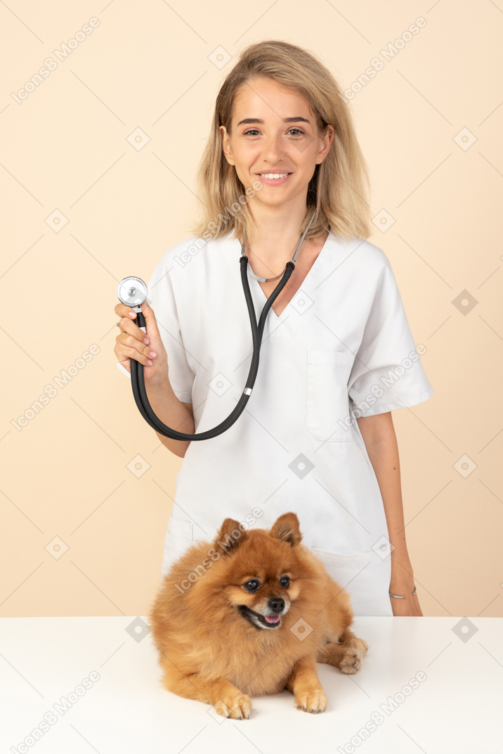 Attractive veterenarian ready to examine a spitz