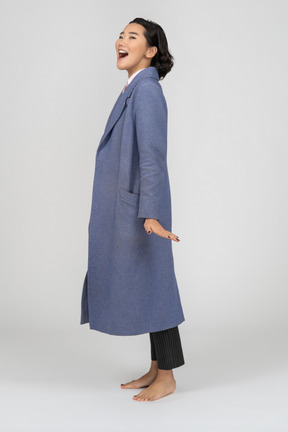 Side view of a happy woman in coat