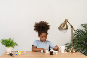 Good looking cute girl doing science at the table