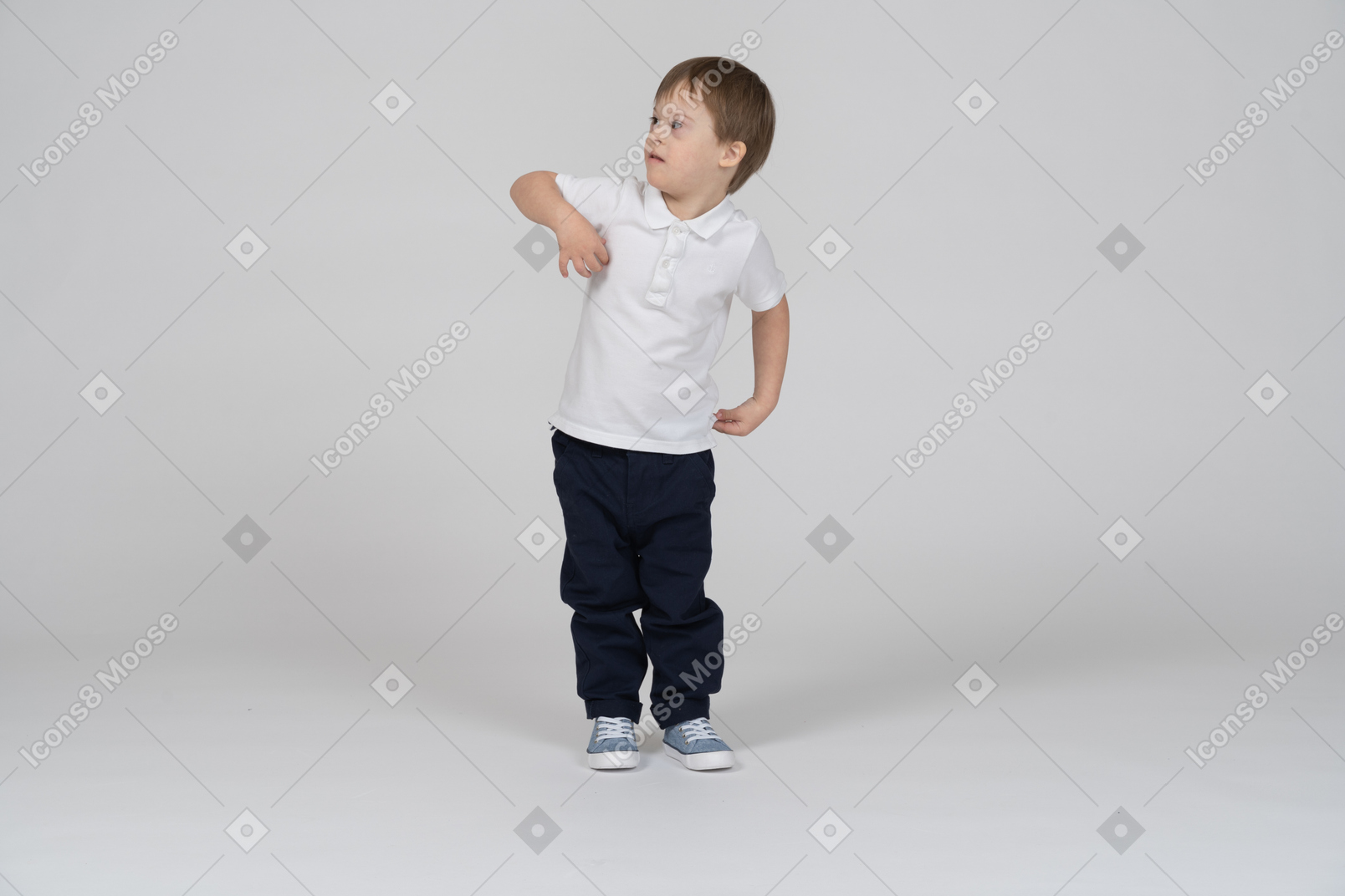 Front view of little boy standing and touching his chest