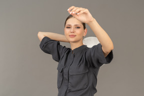 Front view of a young woman in a jumpsuit holding glass plate