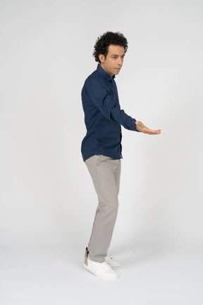 Front view of a man in casual clothes giving a hand