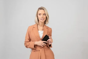 Contemplative young woman holding a smartphone
