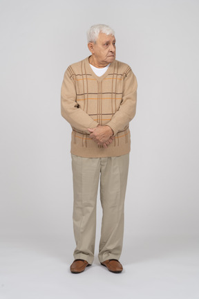 Vista frontal de um velho em roupas casuais, olhando de lado