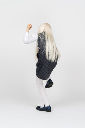 Back view of a schoolgirl celebrating