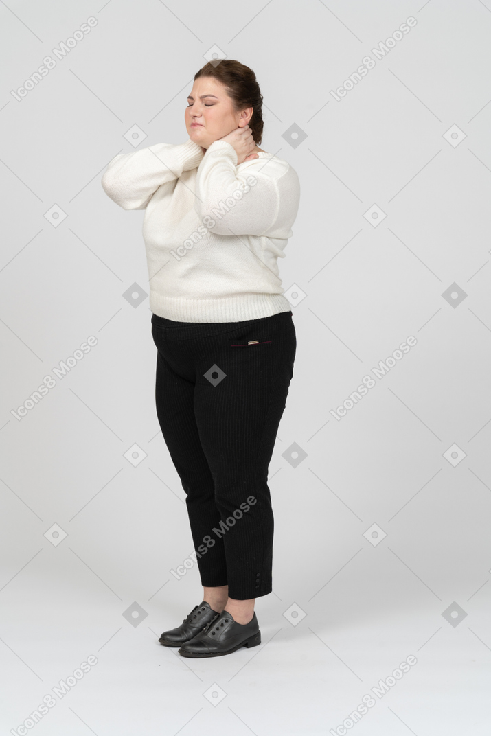 Donna grassoccia in abiti casual che soffre di dolore al collo