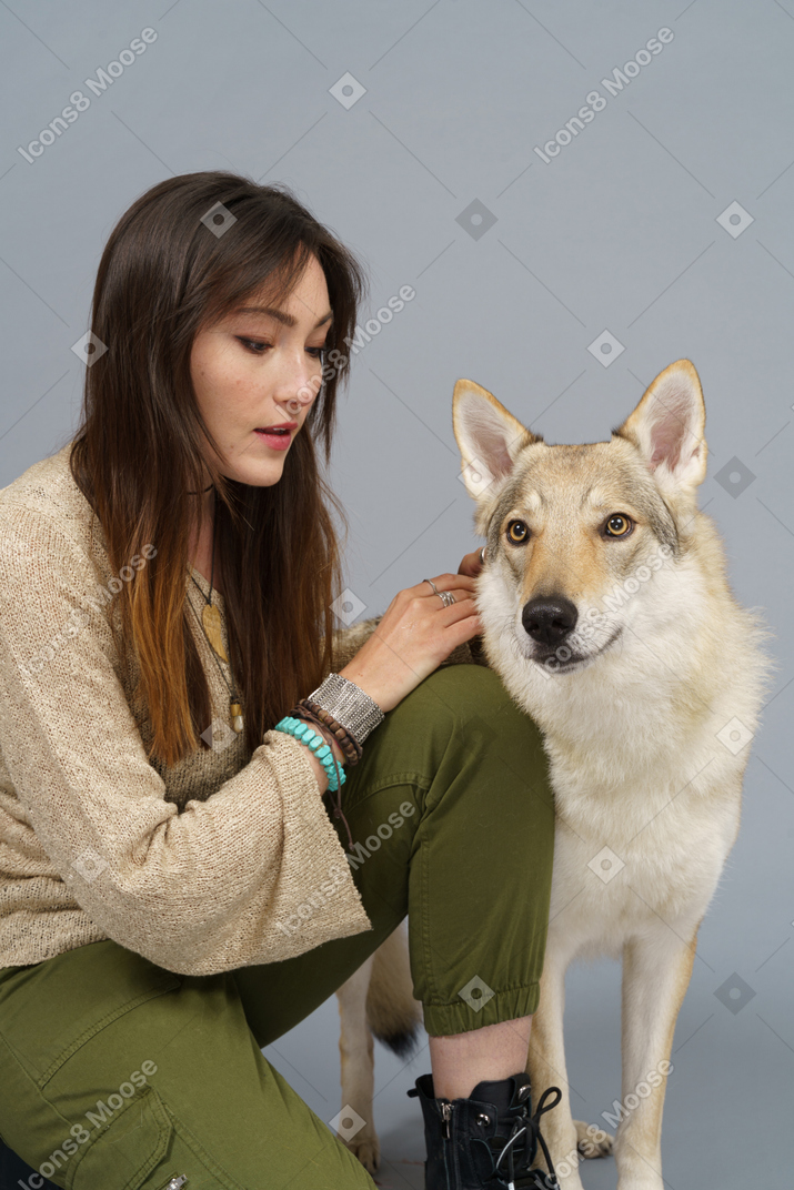 Close-up of a young female master looking at her dog