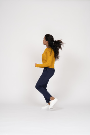 Side view of a girl in casual clothes running