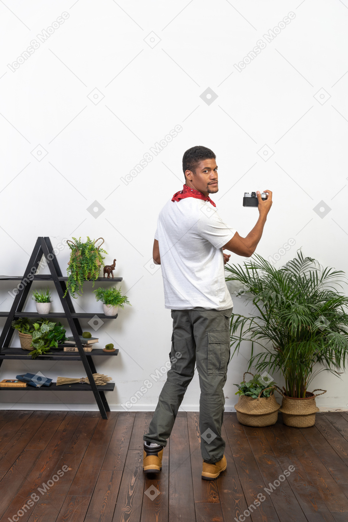 Good looking young man with a camera