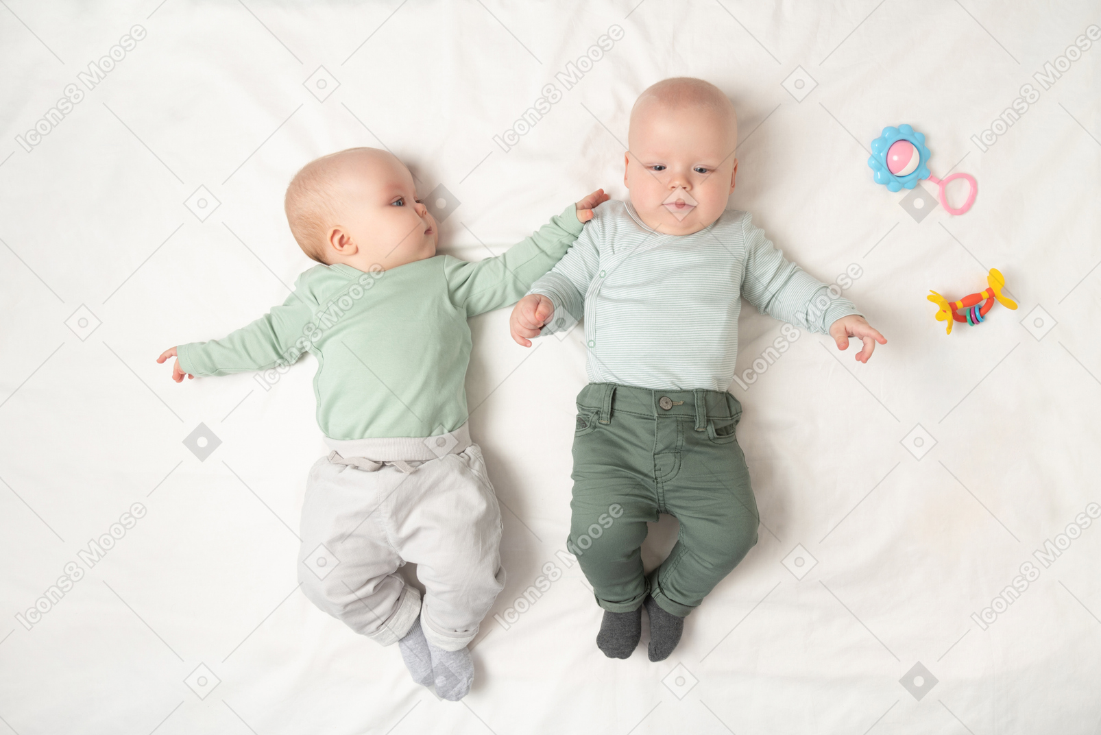 Babies twins lying on the back next to each other