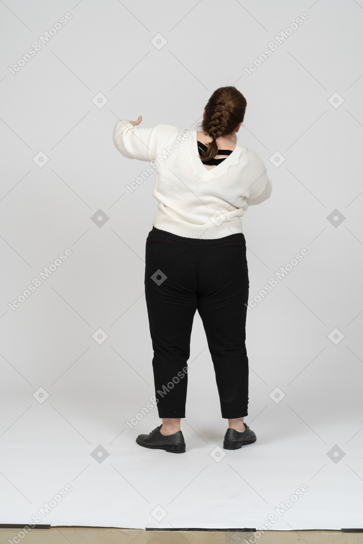 Plump woman in casual clothes posing